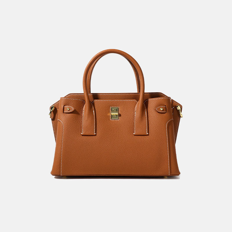 Brown leather handbag on a light gray background