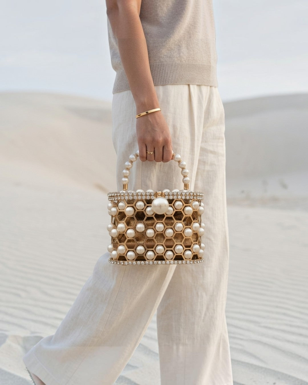 Pine Drew India Aurelia Pearl Lattice minaudière with champagne-gold honeycomb frame and pearl accents in a desert