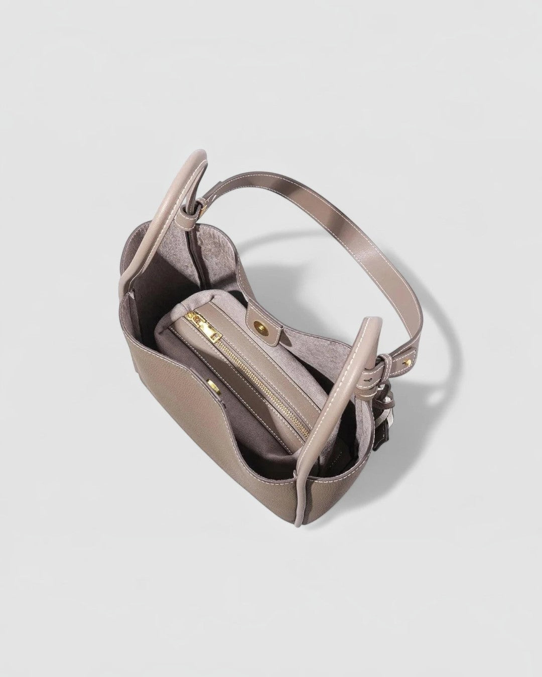 Pine Drew India Becca tote bag in taupe vegan leather with gold hardware and interior zipper pocket, top view.