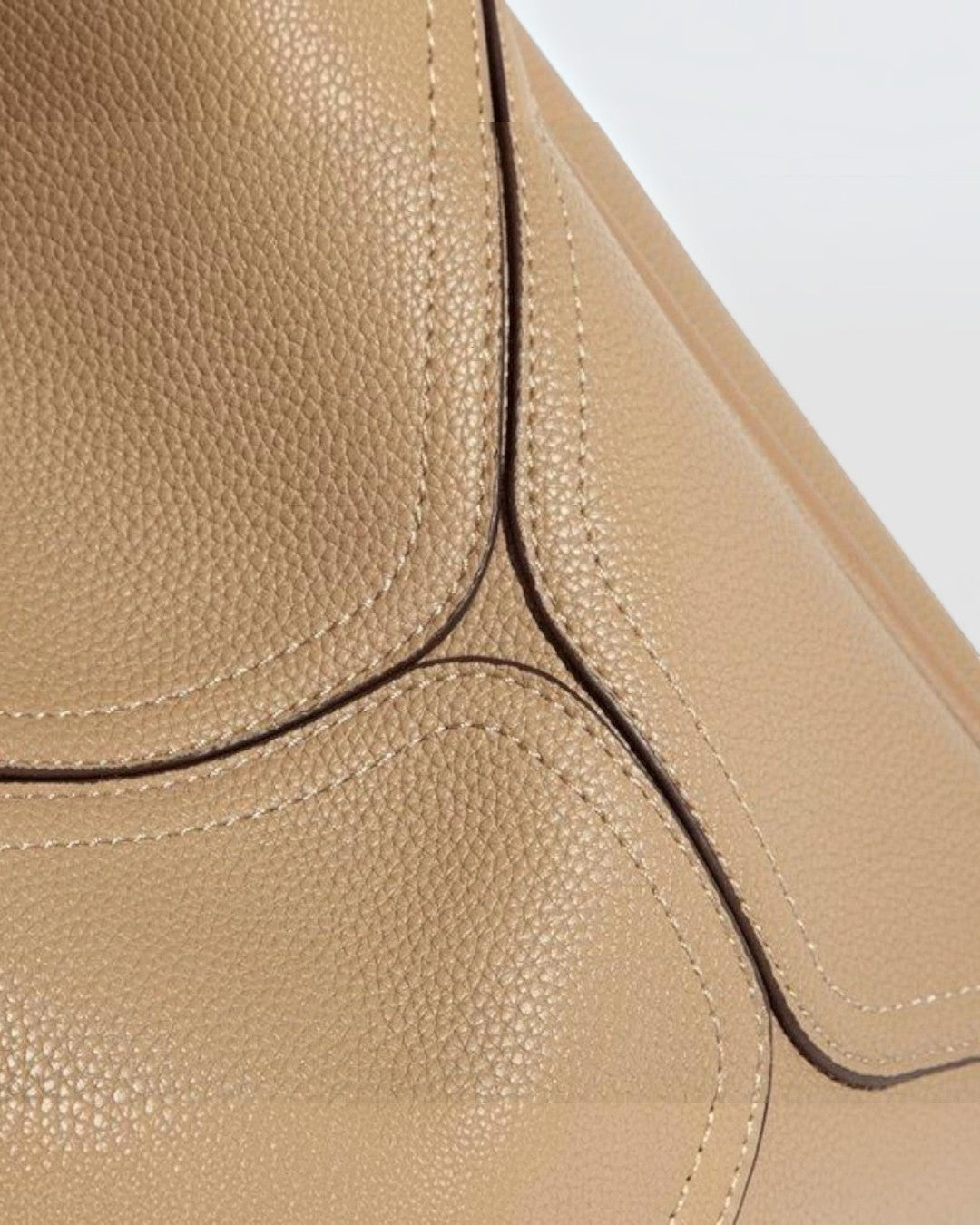 Close-up of Pine Drew India Becca tote bag in beige pebbled vegan leather with detailed stitching