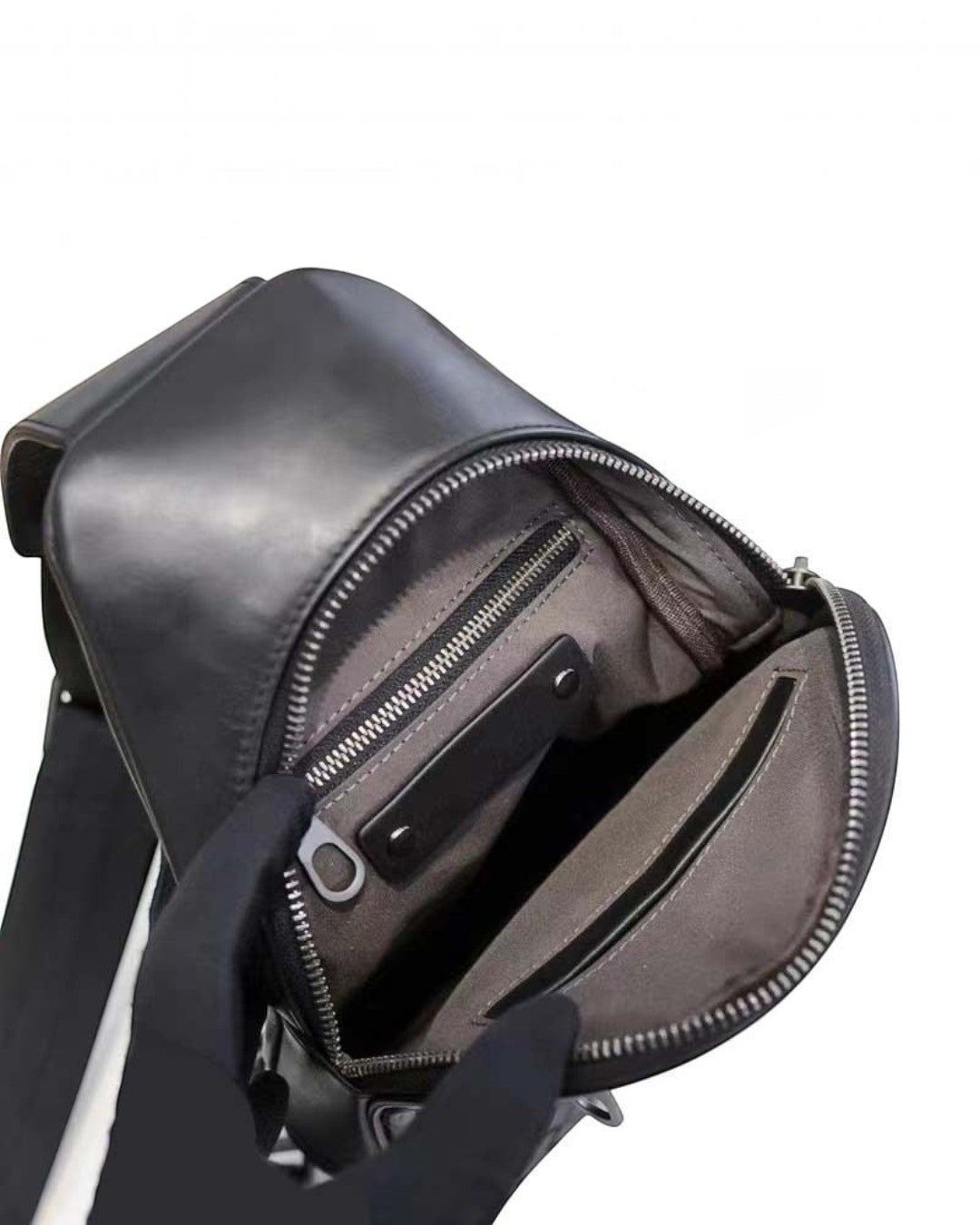 Pine Drew India Woven Voyager black leather sling bag interior view showing fabric lining and zippered pocket
