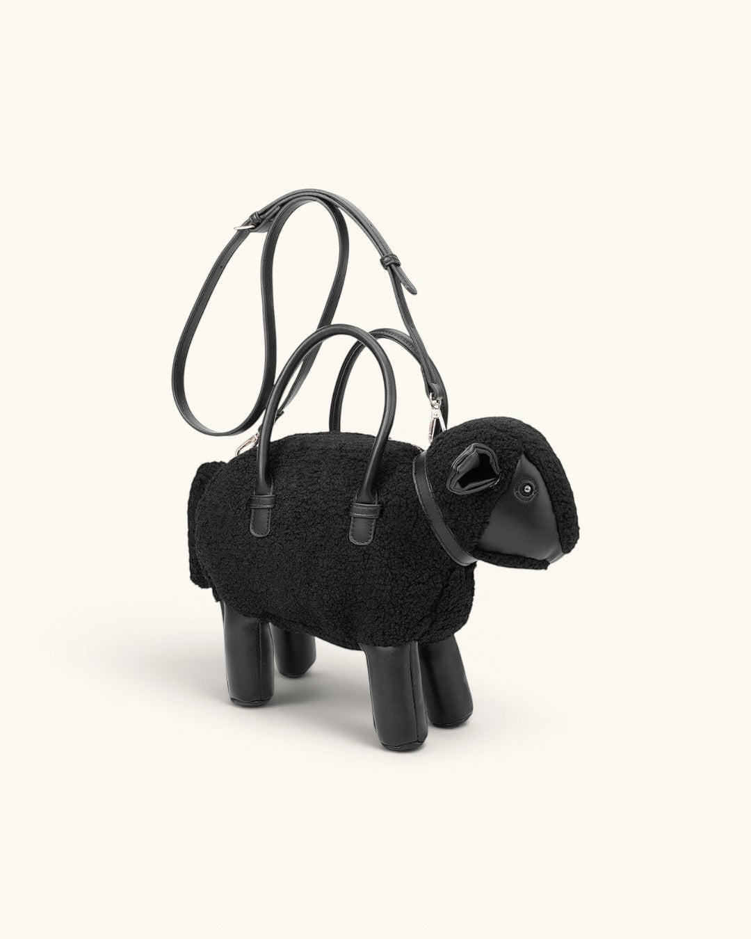 Pine Drew India black sheep-shaped mini bag in teddy shearling and vegan leather with top handles and shoulder strap.