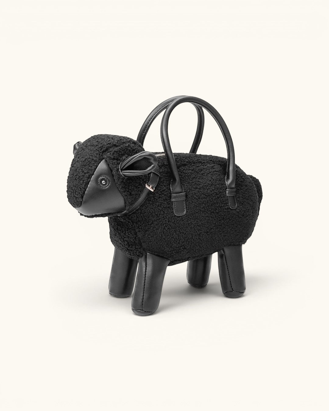 Pine Drew India Montone Mini sheep-shaped handbag in black teddy shearling and vegan leather with gold hardware.