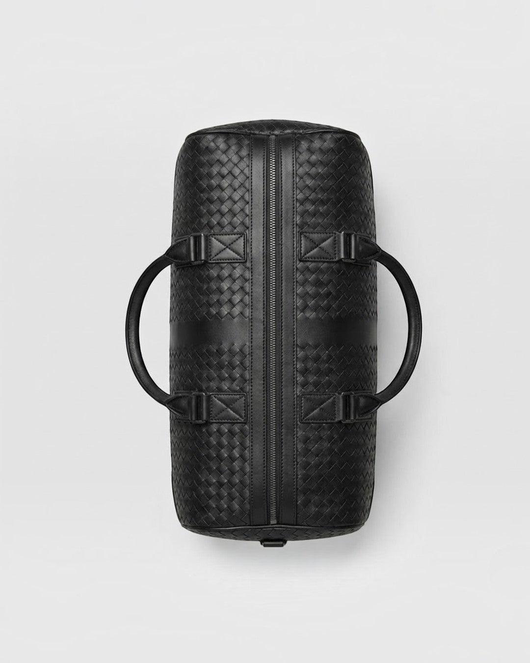 Top view of Pine Drew India black leather Monaco Woven Duffle bag with signature woven texture and zip closure.