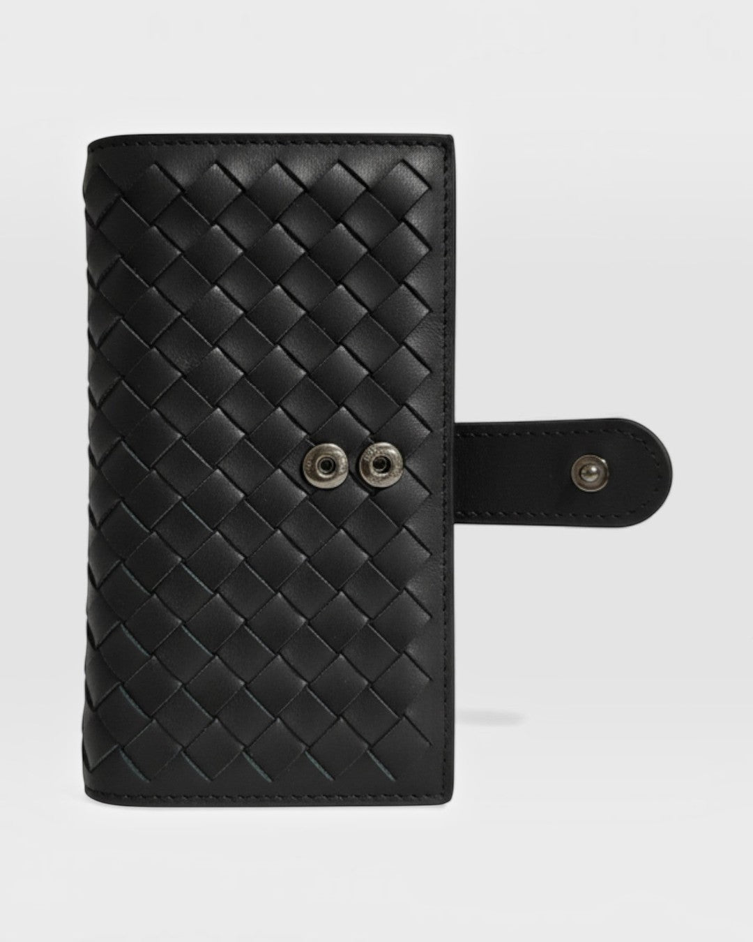 Pine Drew India Caden Interlace long wallet in black woven leather with a secure strap and snap button closure.