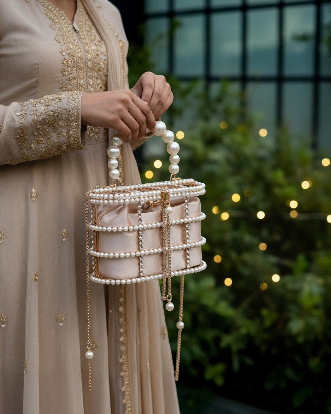Pine Drew India blush satin casket bag with a pearl and crystal lattice overlay and sculptural pearl handle.