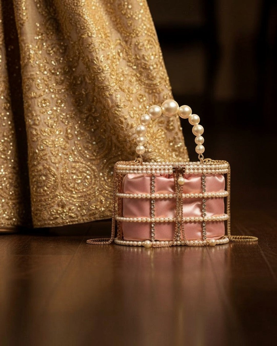 Pine Drew India blush satin casket bag with a pearl and crystal lattice overlay and sculptural pearl top handle.