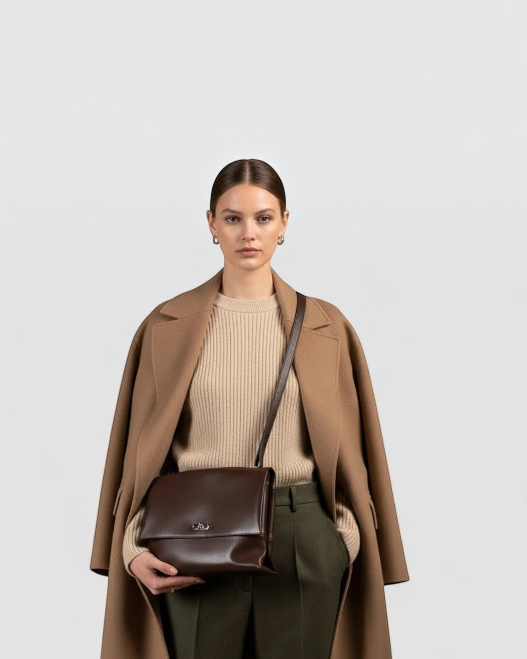 Model wearing Pine Drew India Cacao Luxe leather shoulder bag with silver hardware and soft-folded silhouette