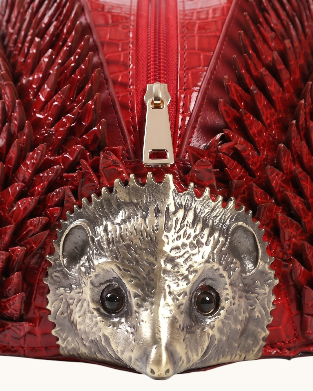 Pine Drew India Epinelle Mini deep crimson croc-embossed vegan leather hedgehog bag with sculptural brass face detail