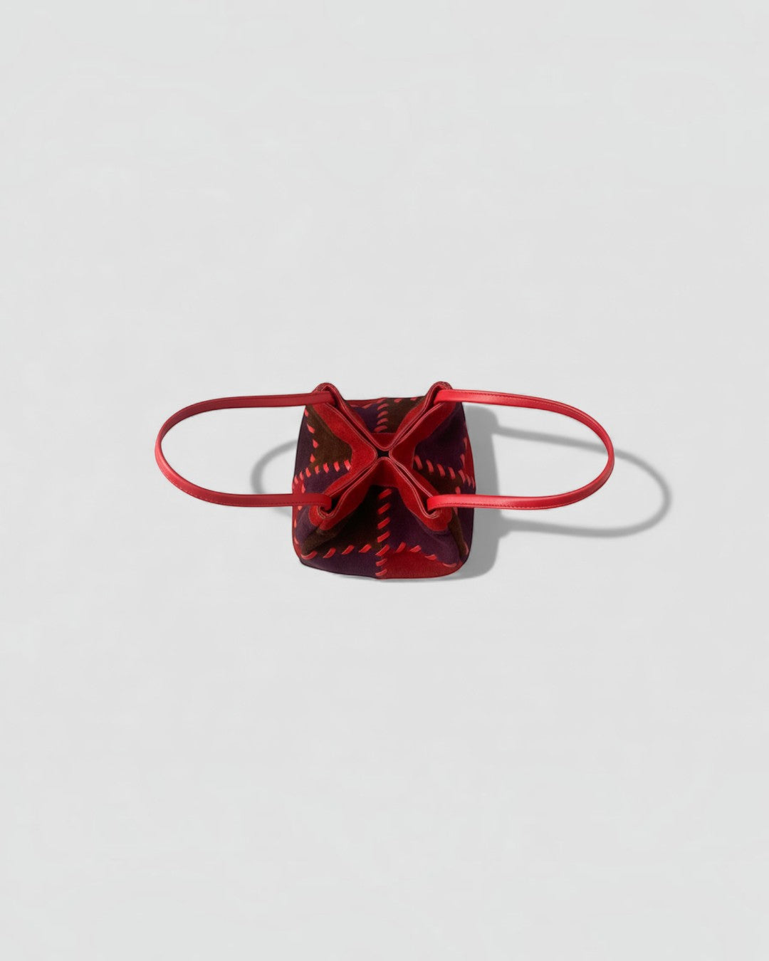 Pine Drew India Luna Mosaic handbag featuring a sculptural patchwork of red and brown suede with contrast stitching.