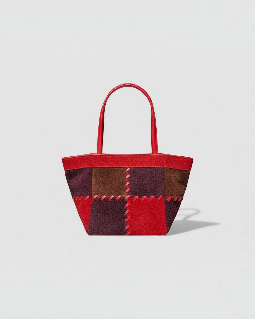 Pine Drew India Luna Mosaic handbag featuring multi-tone suede patchwork panels with red contrast stitching and arc handles
