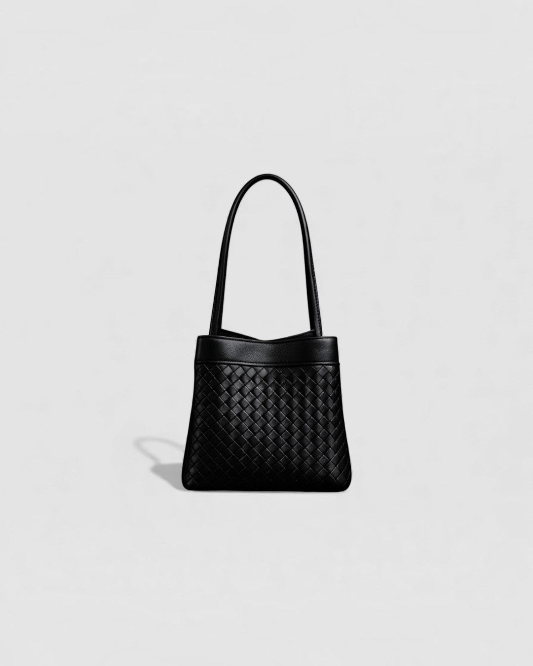 Pine Drew India Luna handbag in espresso brown full-grain leather with an intricate handwoven exterior and arc handles.