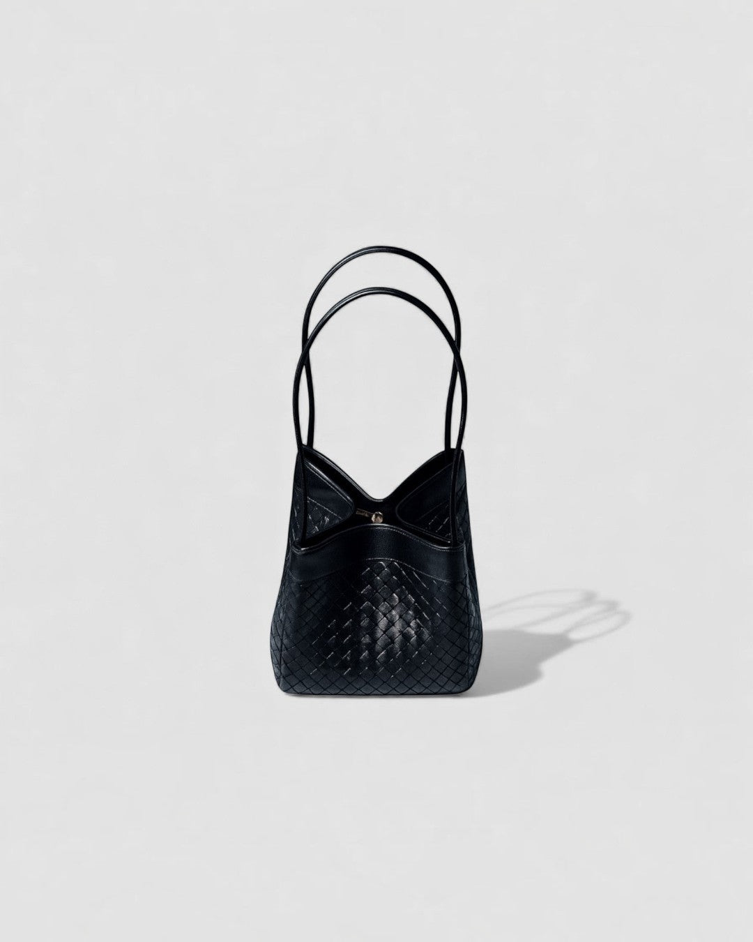 Pine Drew India Luna handbag in espresso brown full-grain leather with an intricate handwoven texture and arc handles.