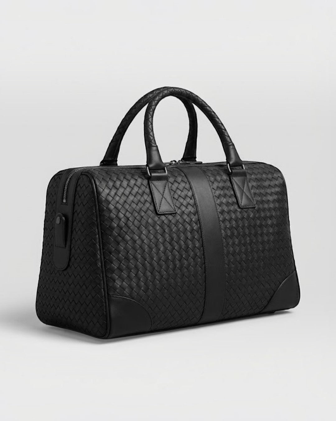 Pine Drew India Monaco woven black leather duffle bag with reinforced handles and structured silhouette