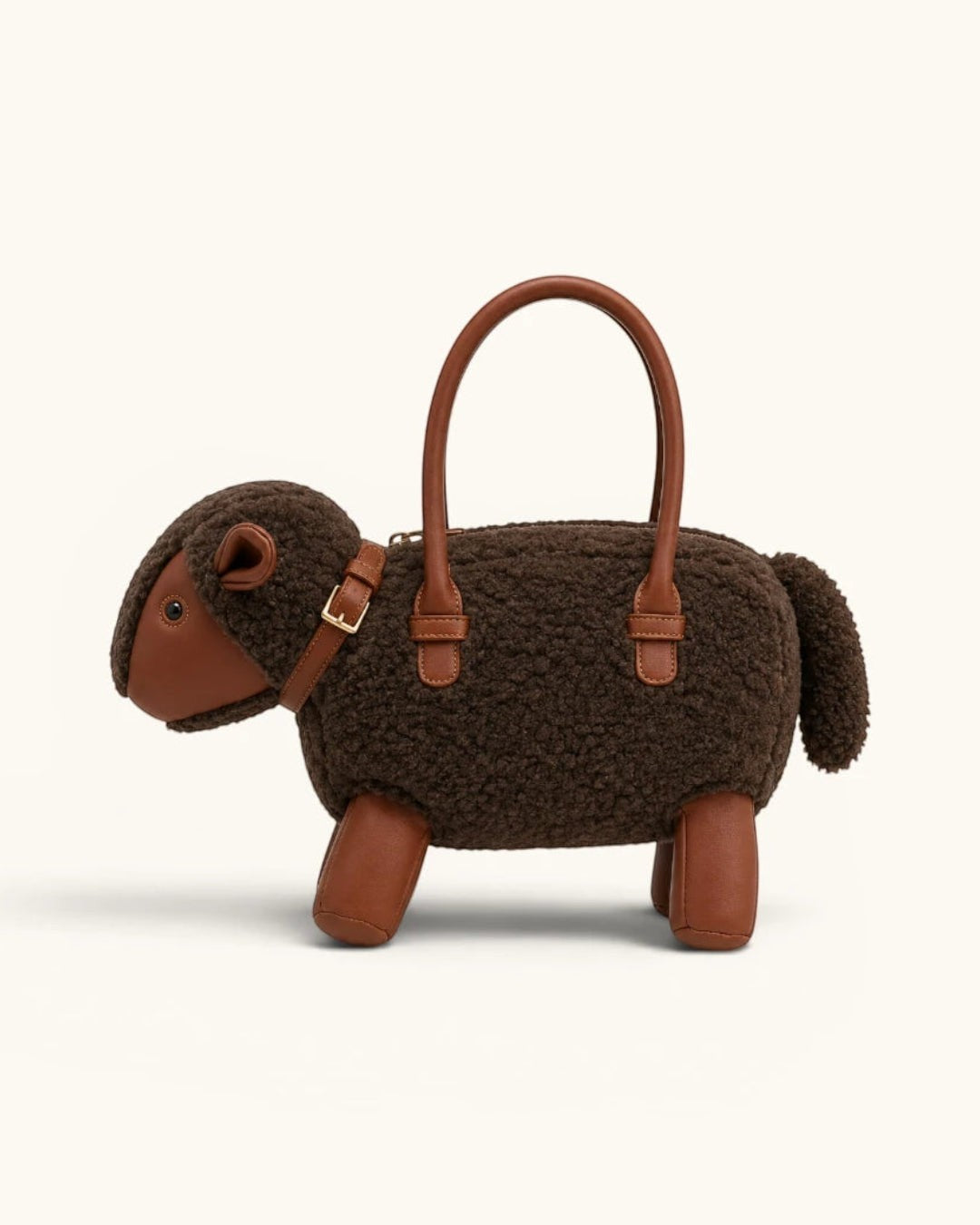 Pine Drew India Montone Mini sheep-shaped bag in chocolate teddy shearling and tan vegan leather with gold buckle.