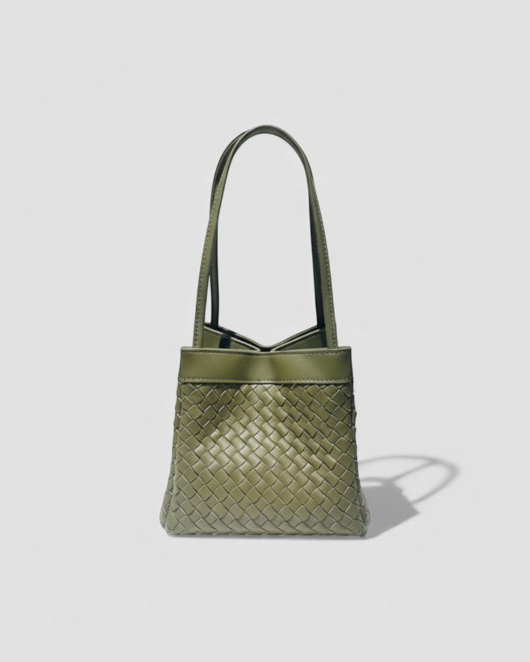 Pine Drew India Luna Verdura olive green woven leather handbag with architectural arc handles and structured shape.