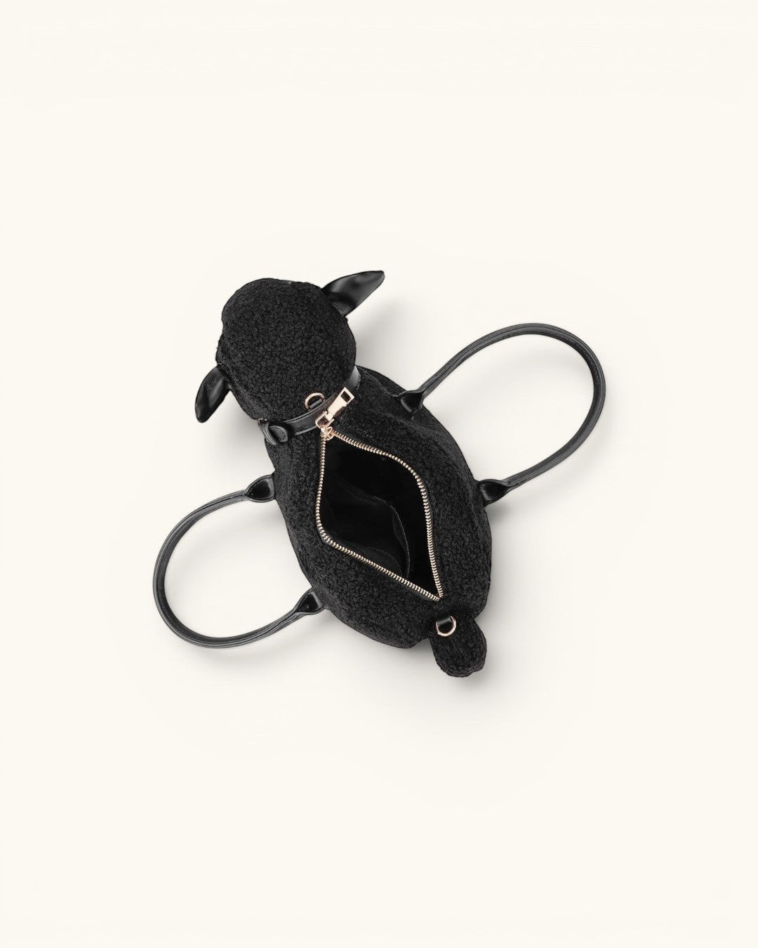 Pine Drew India Montone Mini sheep-shaped bag in black teddy shearling vegan leather with gold hardware and top handles.