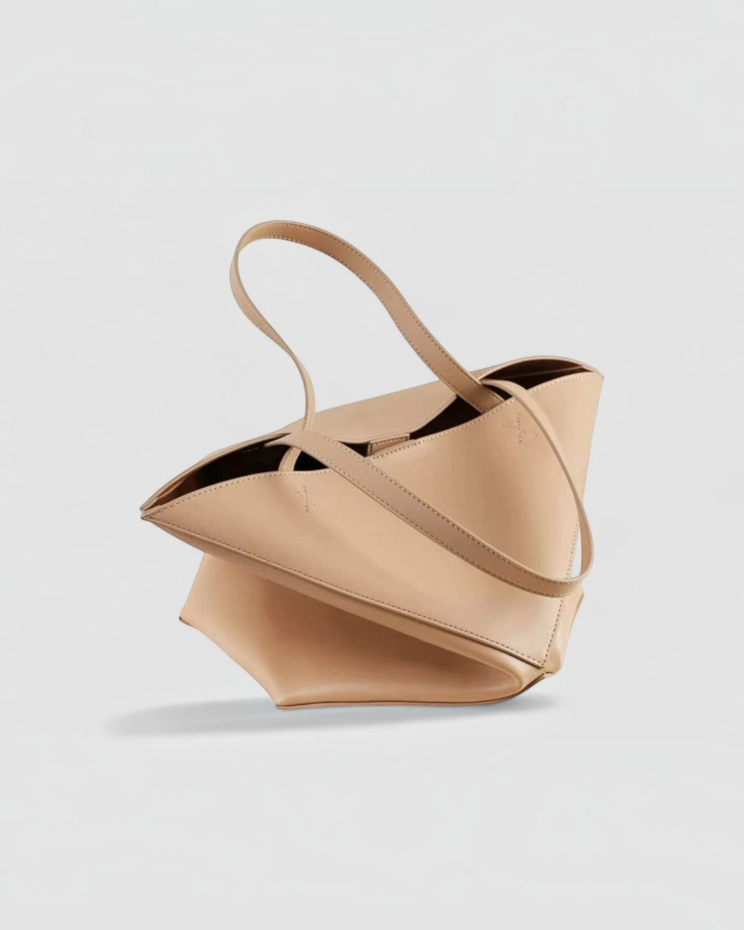 Pine Drew India The EDA tan full-grain leather tote bag with geometric panel construction and dual carry handles.
