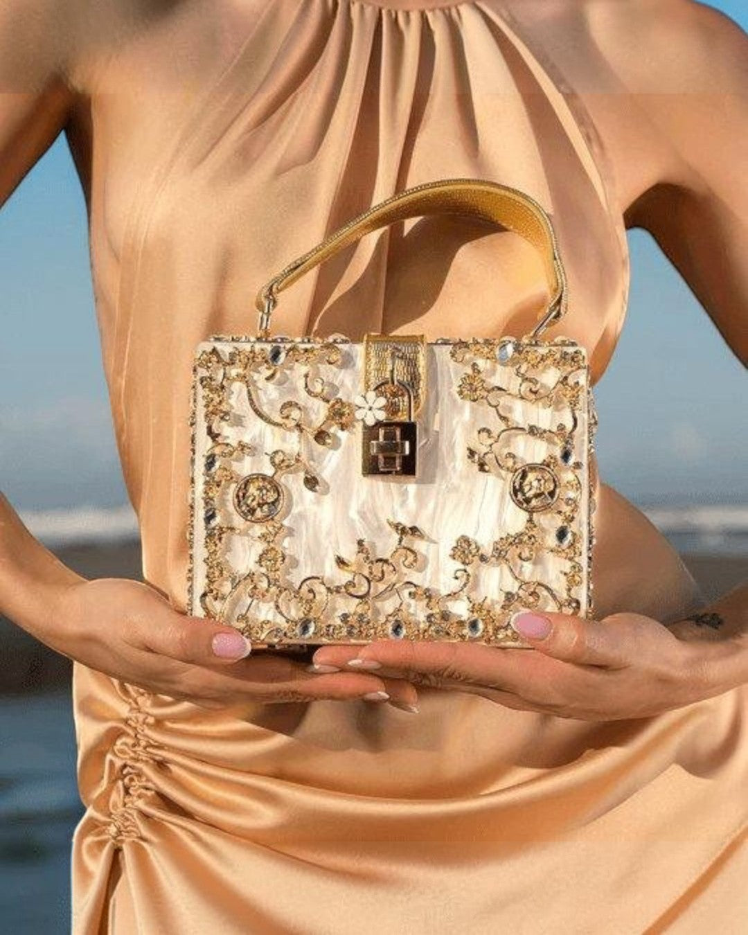 Pine Drew India Bella Box acrylic handbag with gold-plated floral embellishments and a secure turn-up lock