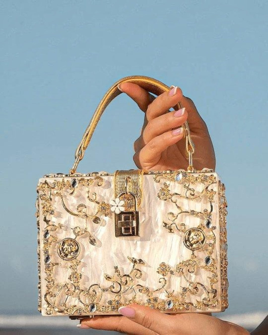 Pine Drew India Bella Box Handbag in white acrylic with gold-plated floral embellishments and a secure turn-up lock.