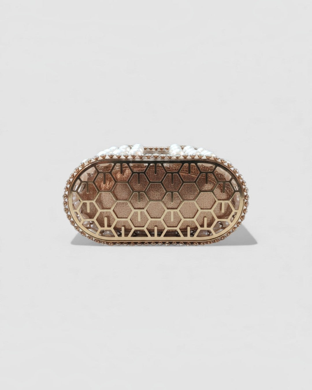 Pine Drew India Aurelia Pearl Lattice minaudière in champagne gold with a honeycomb structure and white pearl accents.