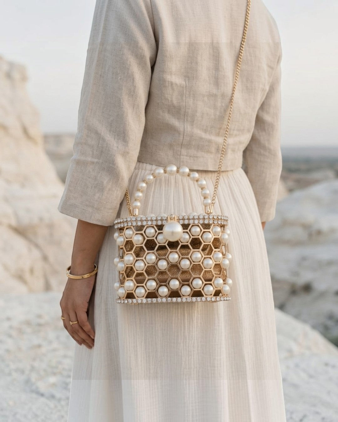 Pine Drew India Aurelia Pearl Lattice minaudière with a champagne-gold honeycomb frame and pearl accents.