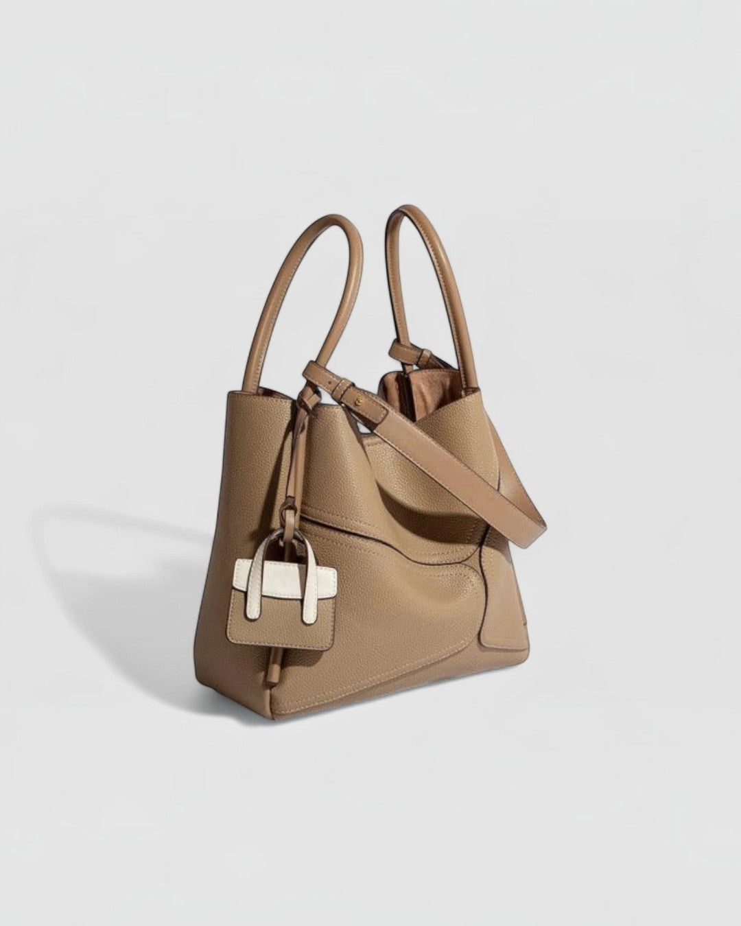 Pine Drew India Becca tote bag in tan vegan leather with gold hardware, top handles, and a detachable shoulder strap.
