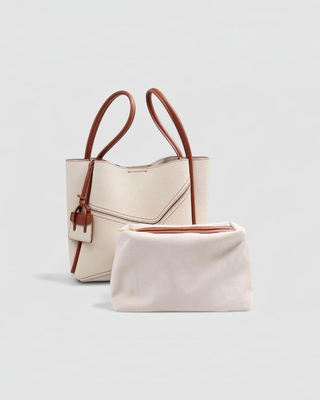 Pine Drew India Becca tote bag in cream vegan leather with brown handles and a matching interior pouch