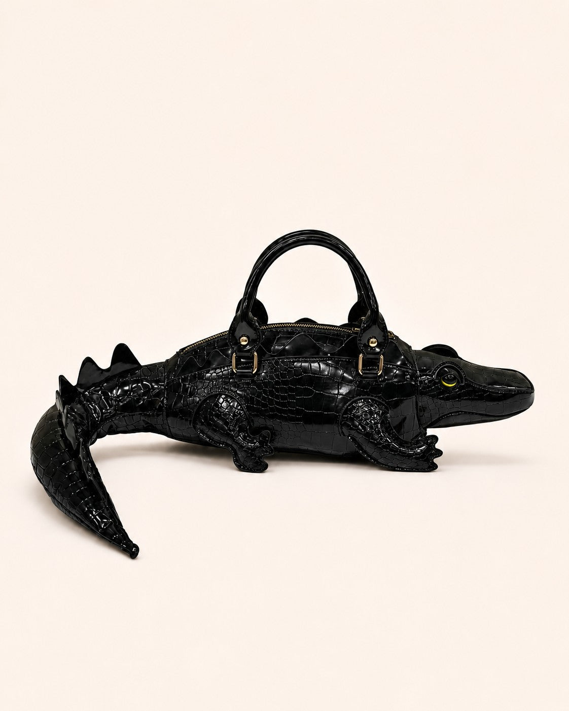Pine Drew India Crocetta Élan mini handbag in black croc-embossed vegan leather with a unique crocodile-shaped design.