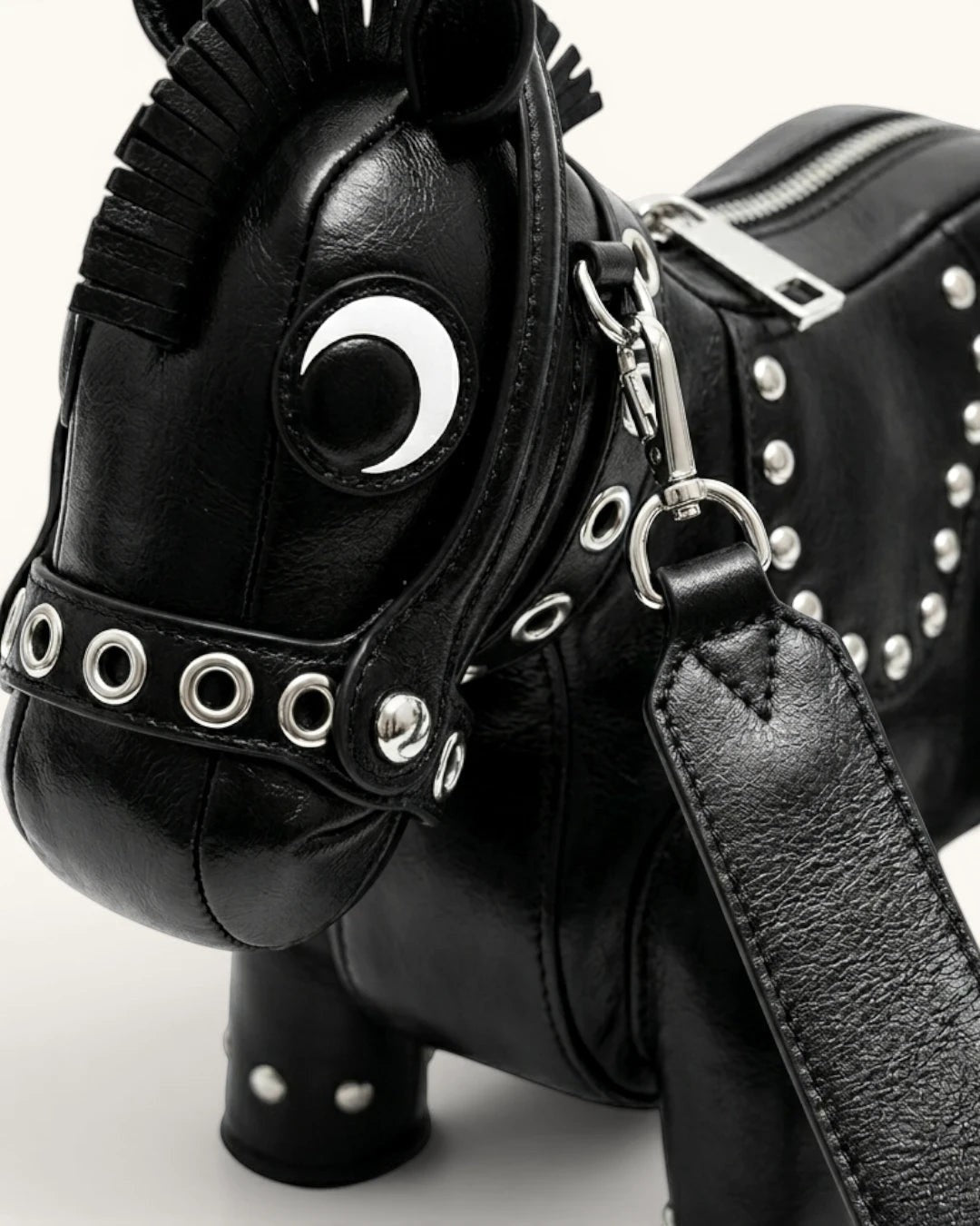Pine Drew India black vegan leather horse-shaped Cavallo handbag with silver stud detailing and crescent moon accent.