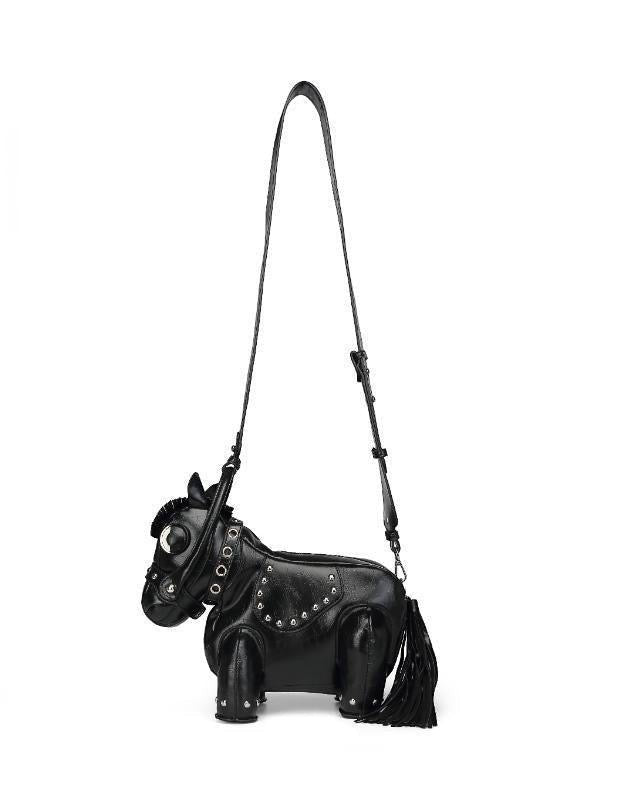 Pine Drew India black vegan leather horse-shaped handbag with gold stud details and a tassel tail.