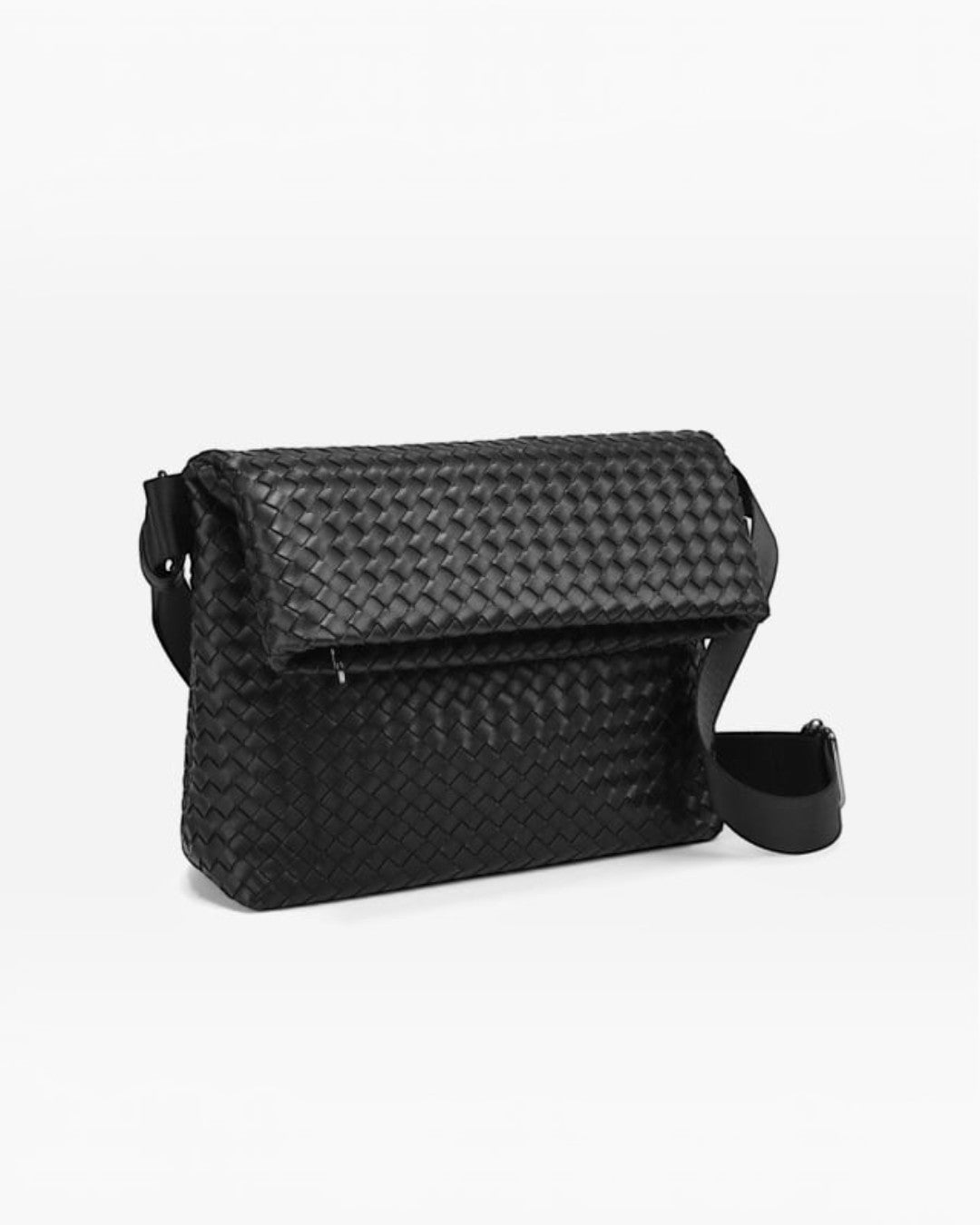 Pine Drew India black vegan leather crossbody bag with a woven foldover design and adjustable shoulder strap.