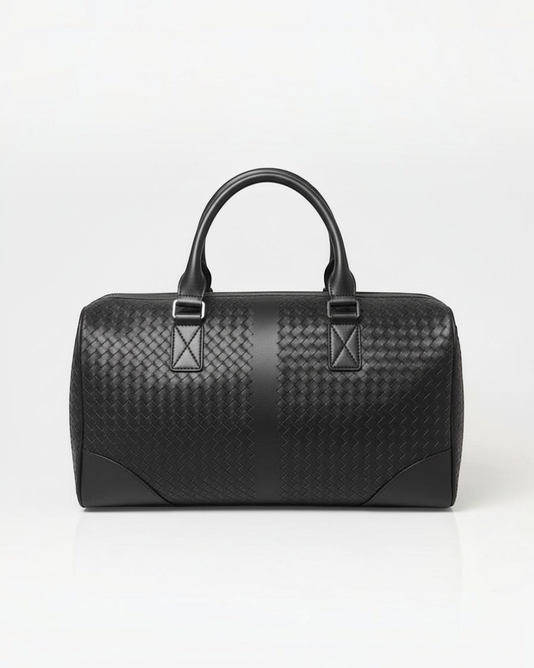 Pine Drew India black leather duffle bag with signature woven detailing, reinforced handles, and silver hardware.