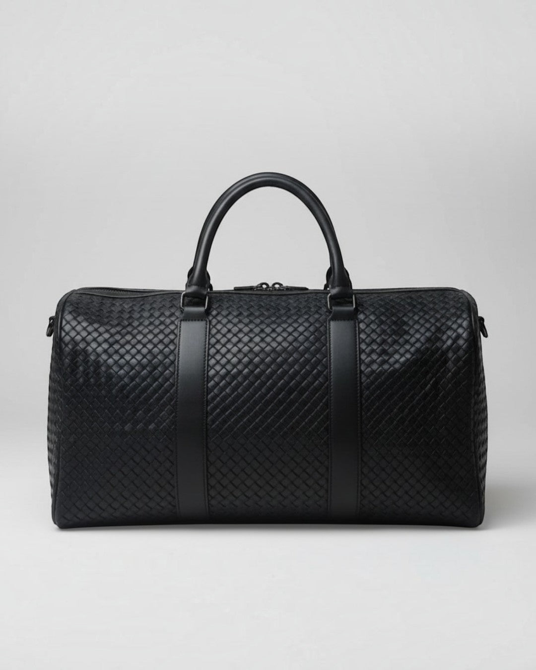 Pine Drew India Elora black vegan leather duffle bag with signature woven detailing and reinforced handles