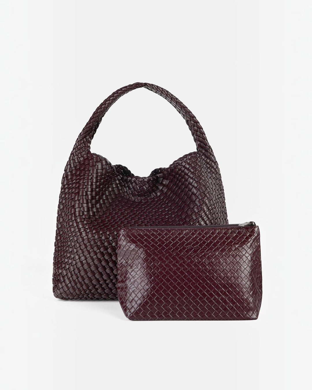 Pine Drew India The Jocelyn handwoven vegan leather shoulder bag in deep burgundy with a matching zippered pouch.