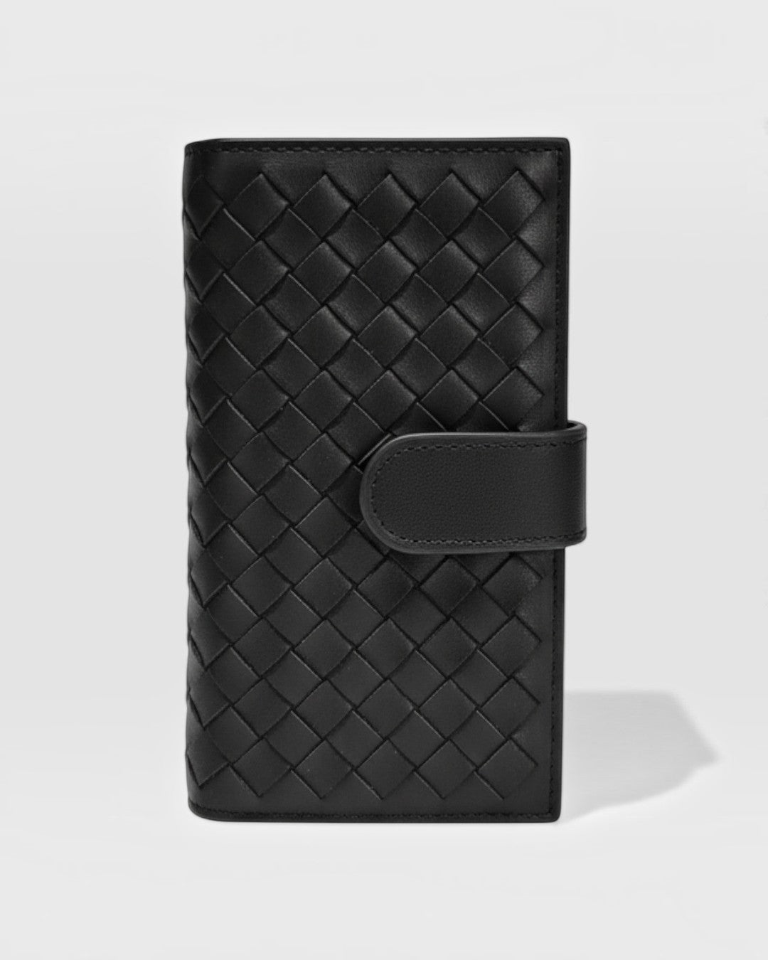Pine Drew India Caden Interlace long wallet in black woven leather with a structured silhouette and snap closure.
