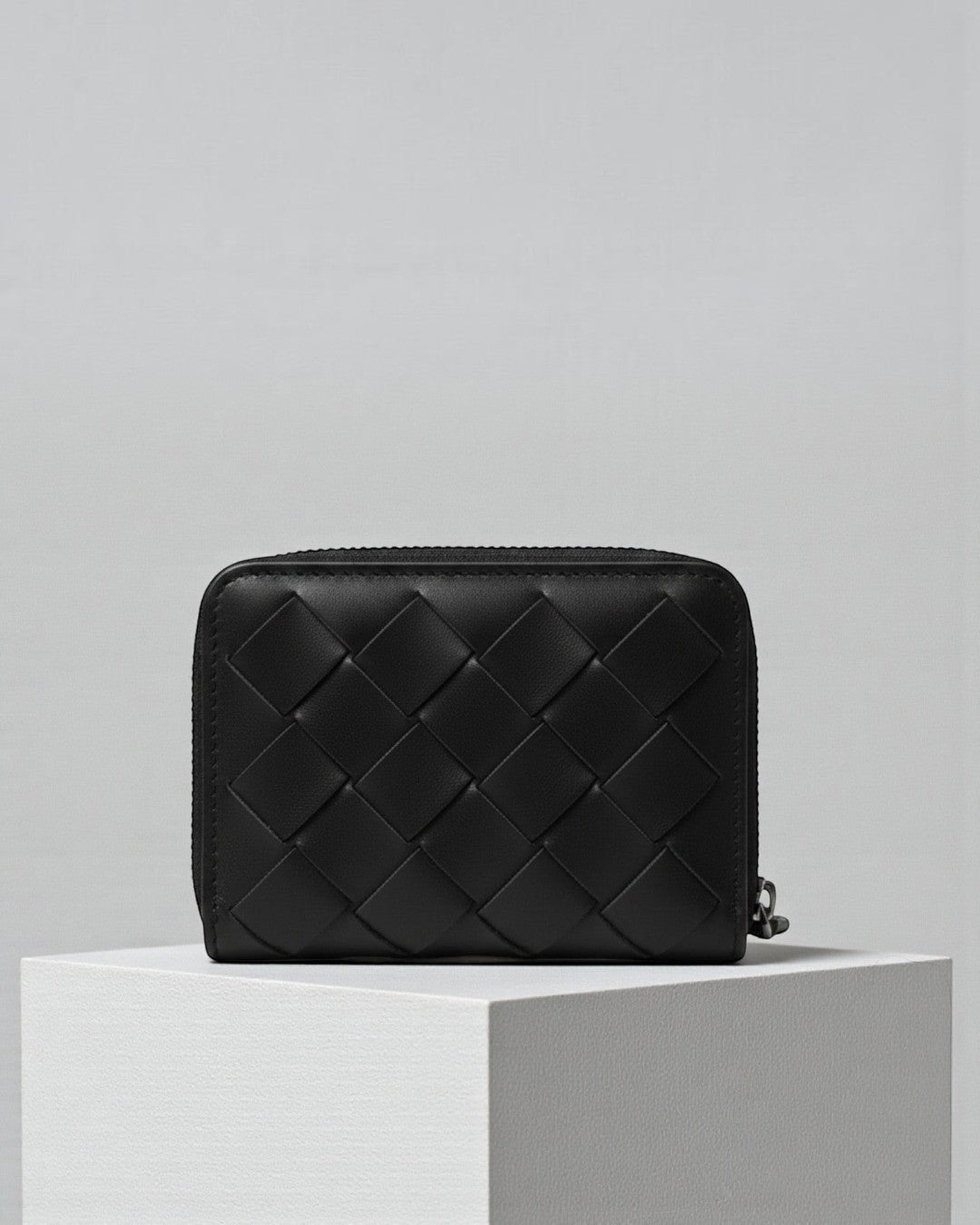 Pine Drew India Caden Interlace zip wallet in black woven leather with a structured, minimalist design.