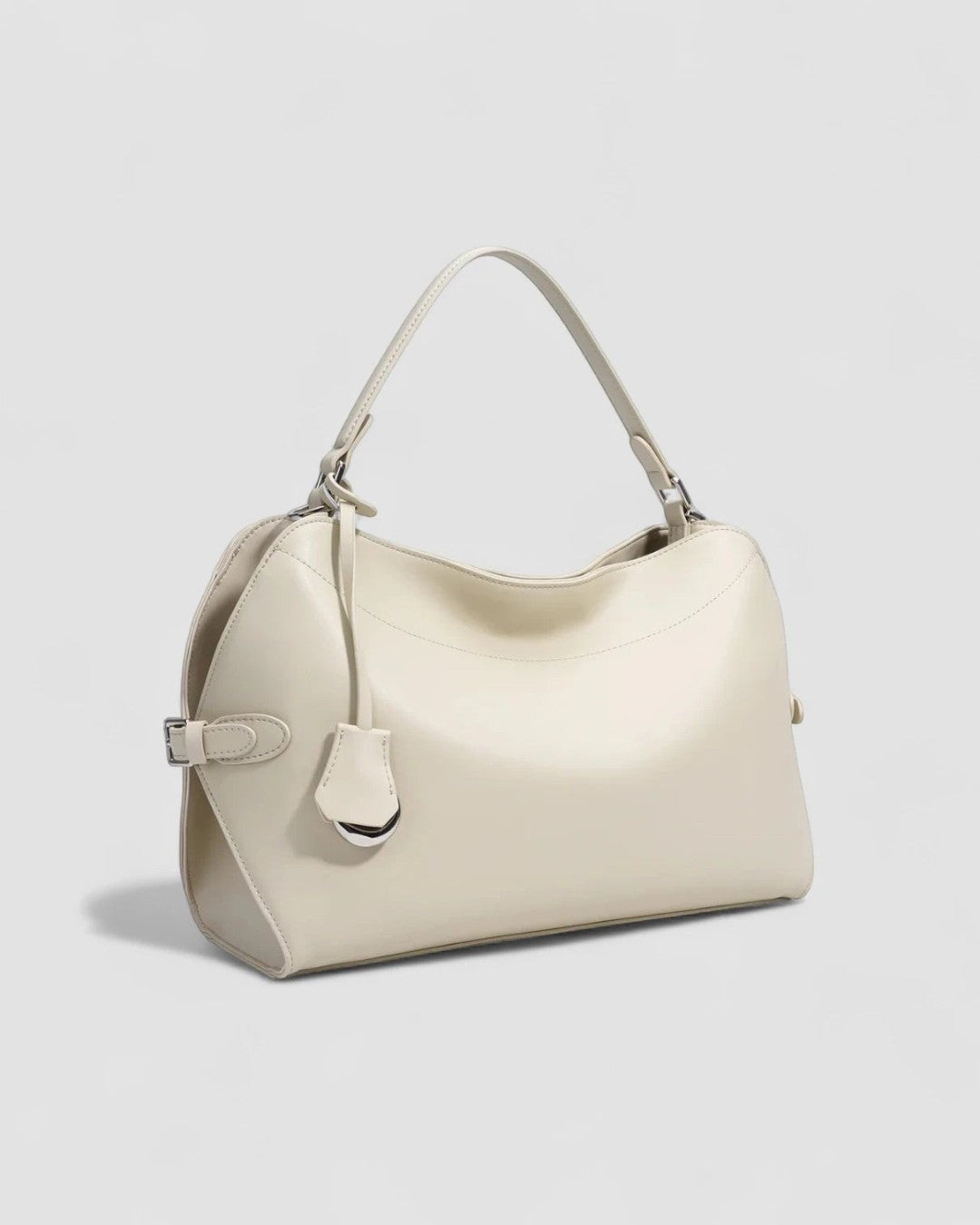 Pine Drew India Celeste hobo bag in off-white pure leather with a sculpted silhouette and polished metal charm.