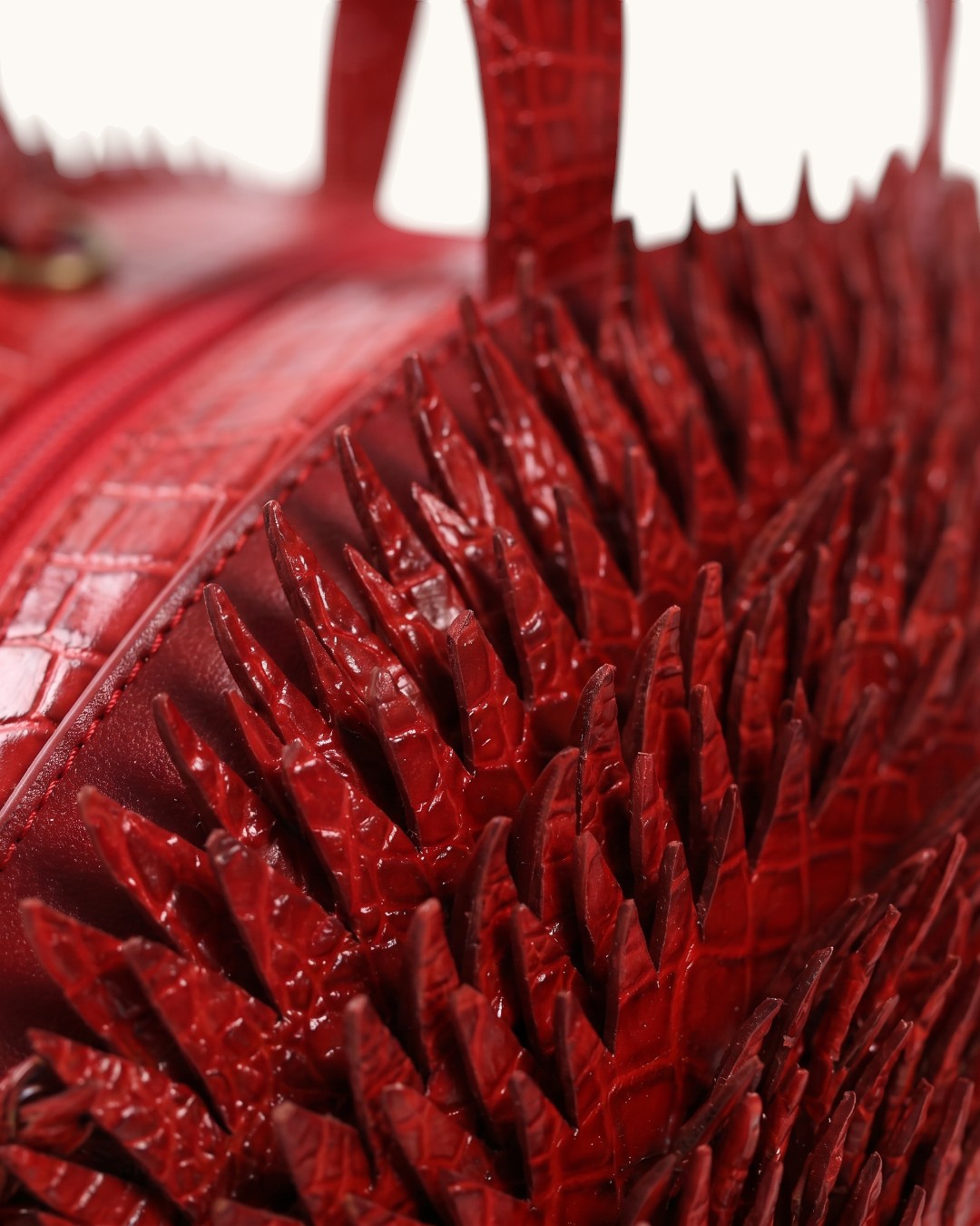 Pine Drew India deep crimson croc-embossed vegan leather hedgehog bag with sculpted leather spines and zip closure