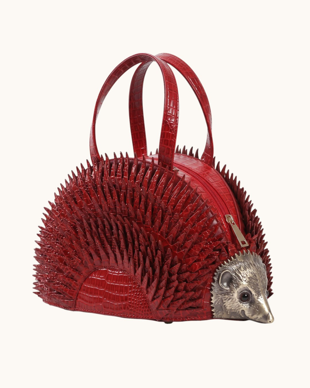 Pine Drew India Epinelle Mini deep crimson croc-embossed vegan leather hedgehog handbag with sculpted brass face.