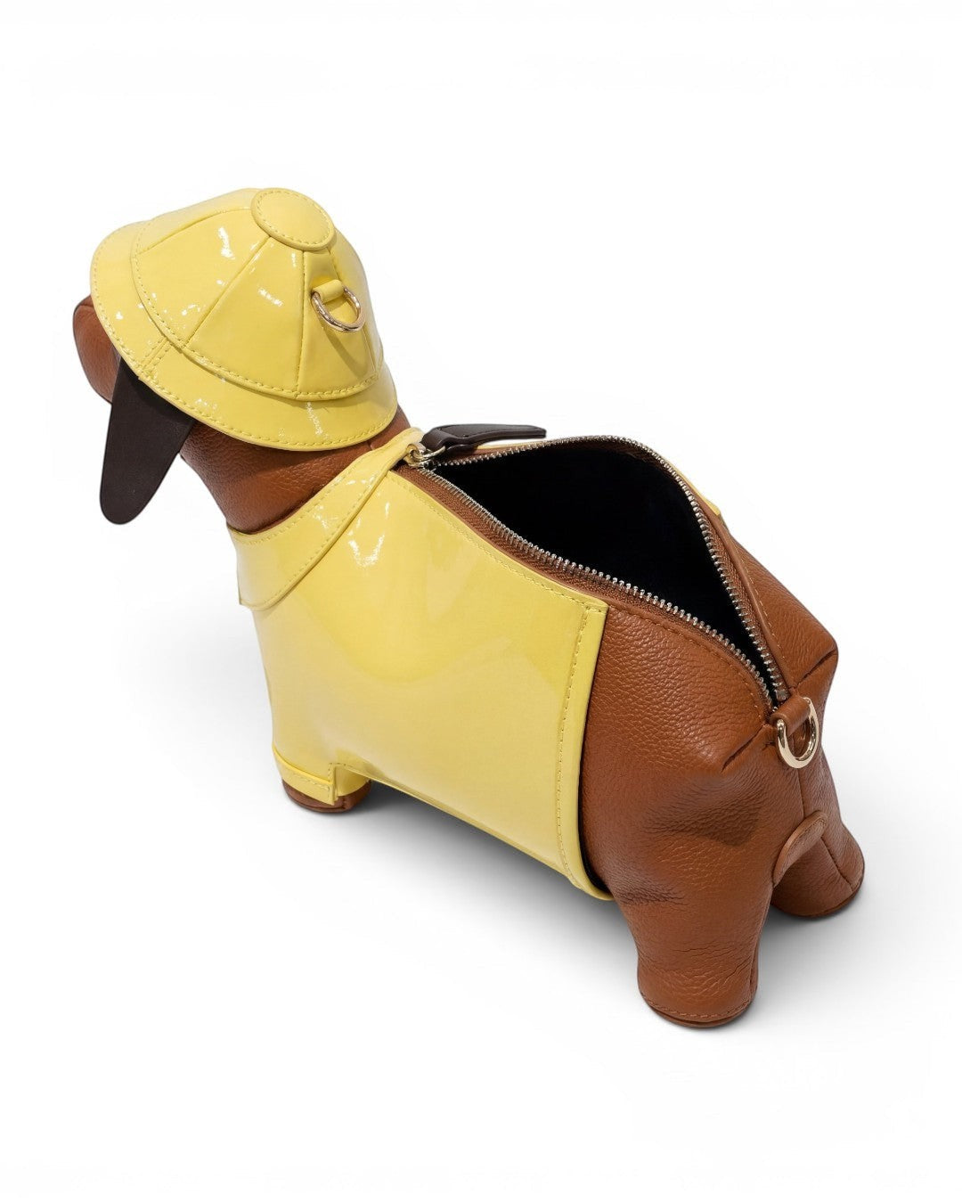 Pine Drew India Dachshund Safari Bag in brown vegan leather with a glossy yellow trench coat and matching safari hat.