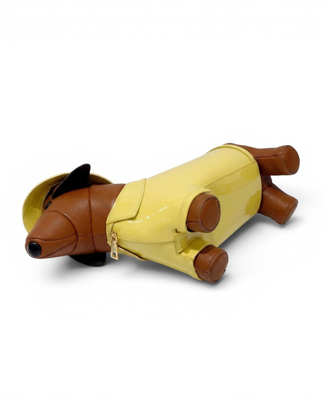 Pine Drew India dachshund shaped bag in brown vegan leather with a glossy yellow trench coat and matching hat