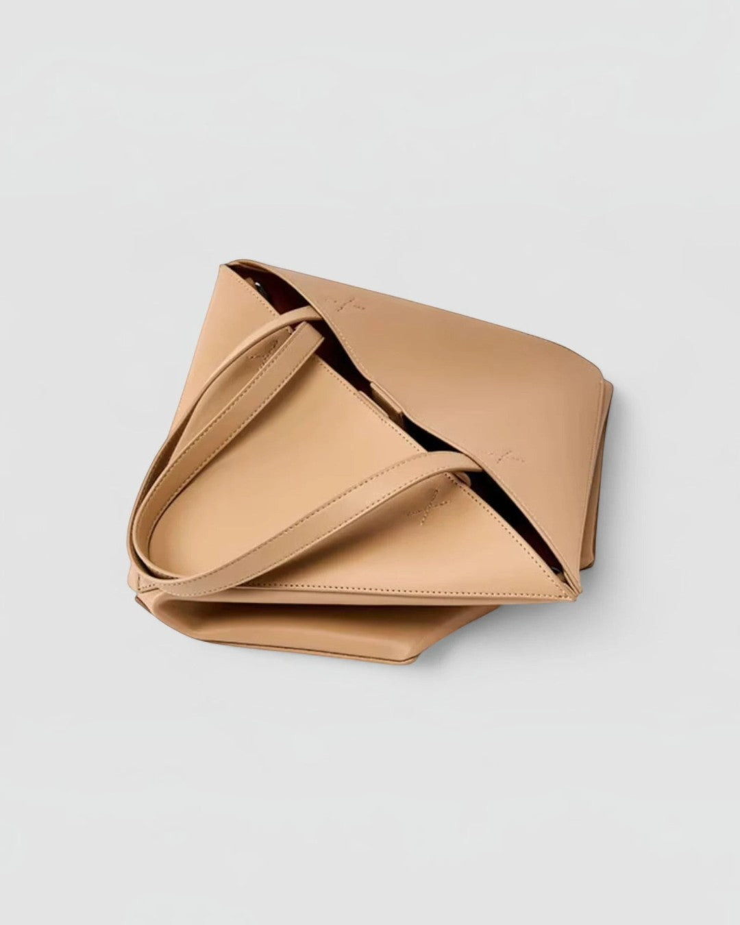 Pine Drew India EDA tan full-grain leather tote bag with geometric panel construction and dual carry handles