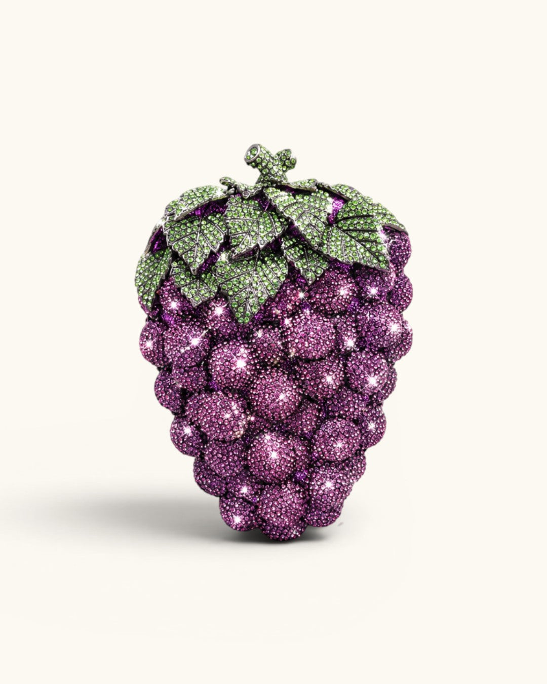 Pine Drew India Vitis Luxe Clutch in a grape bunch shape, fully encrusted with violet and emerald green crystals.