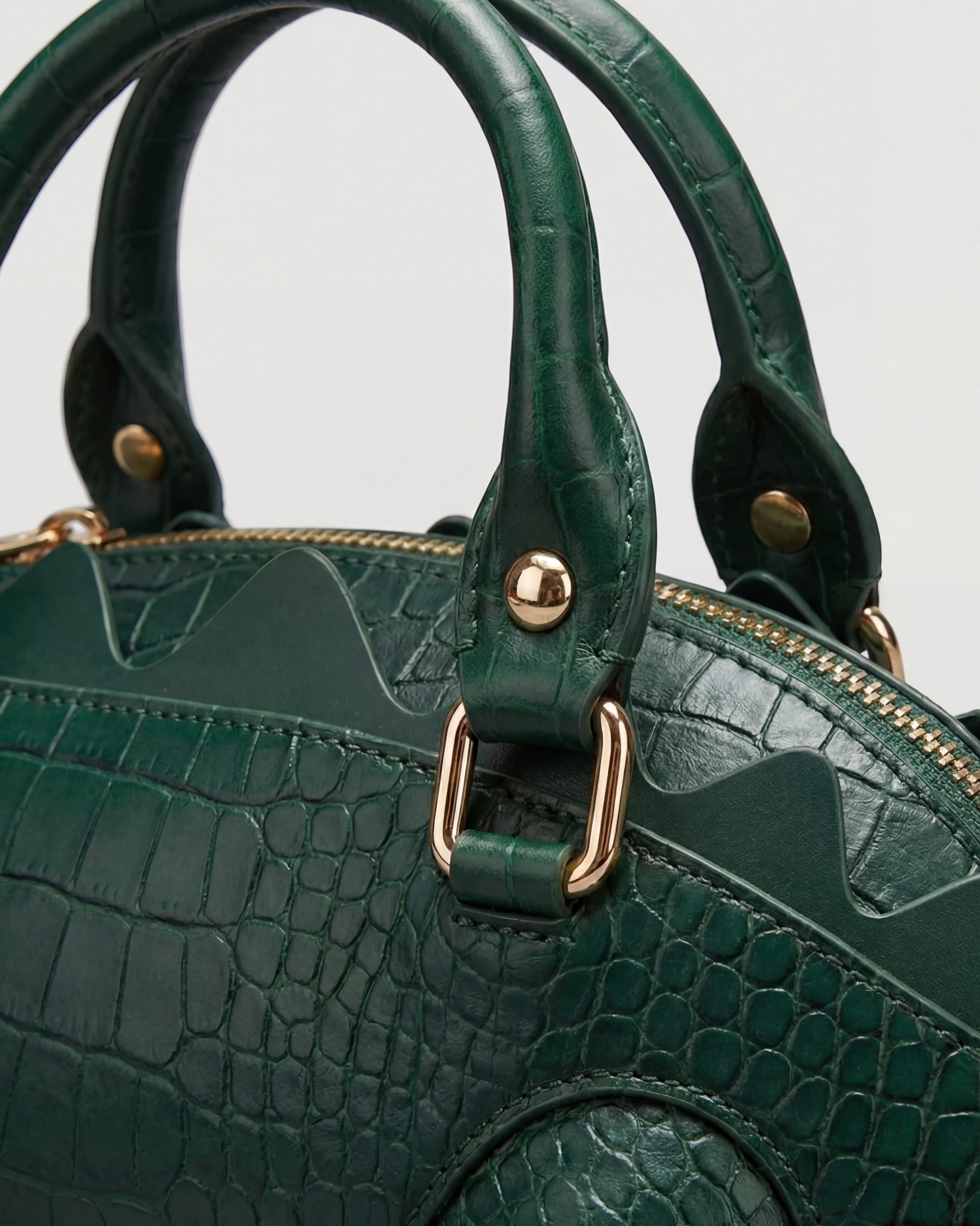 Pine Drew India Crocetta Élan mini handbag in deep green croc-embossed vegan leather with polished gold hardware.