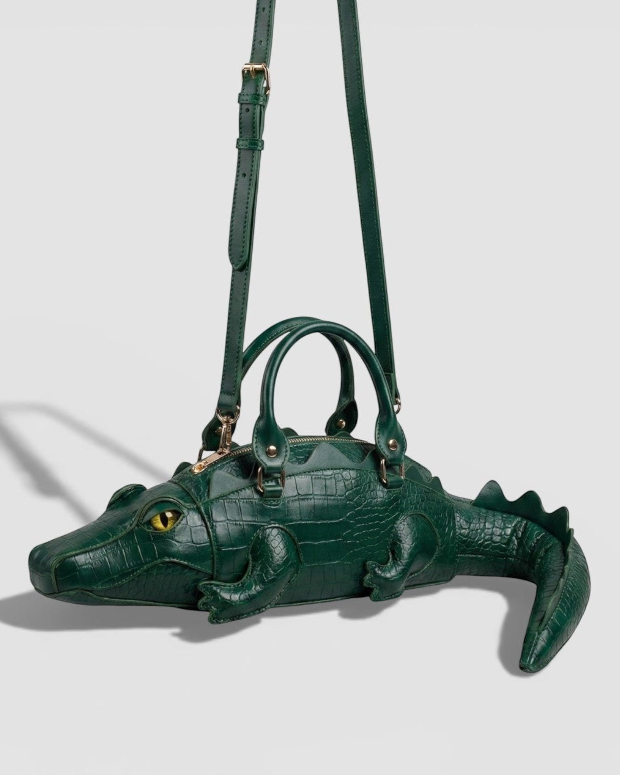 Pine Drew India Crocetta Élan mini handbag in deep-green croc-embossed vegan leather with gold hardware and strap.