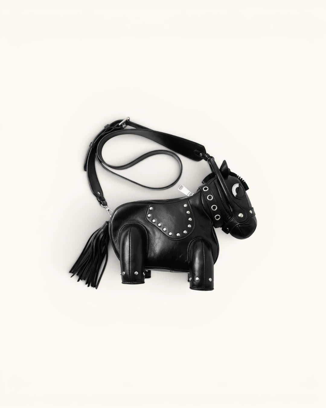 Pine Drew India black vegan leather horse-shaped handbag with silver stud details and a tassel tail.