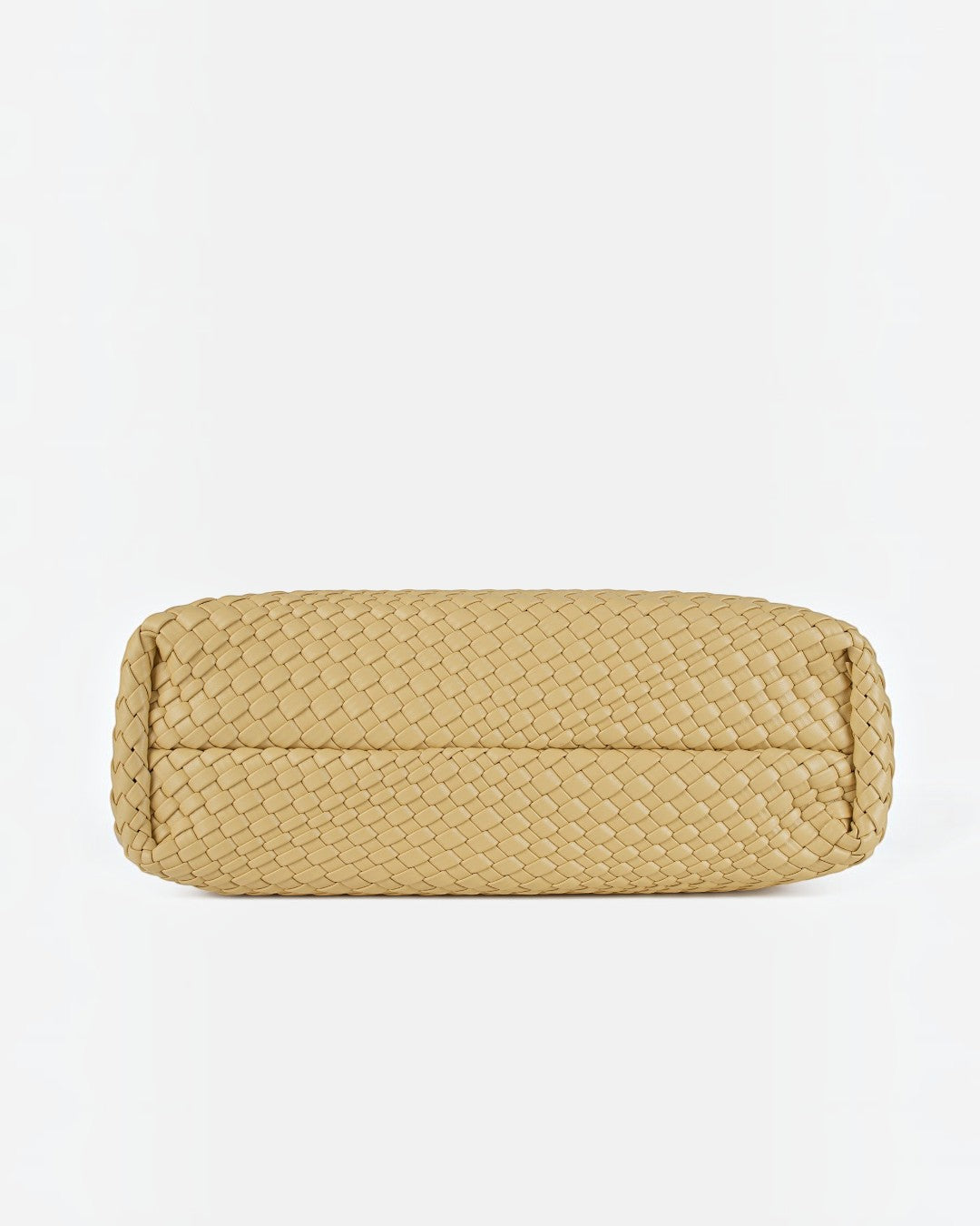 Pine Drew India The Jocelyn bag featuring a beige handwoven vegan leather flat base for an upright hold.
