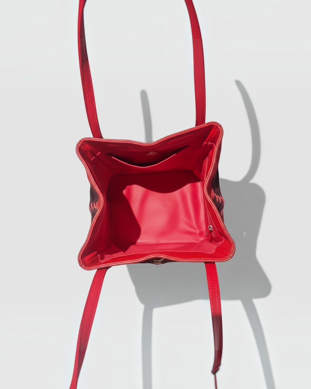 Pine Drew India Luna Mosaic handbag interior view showing red leather lining and structural square silhouette