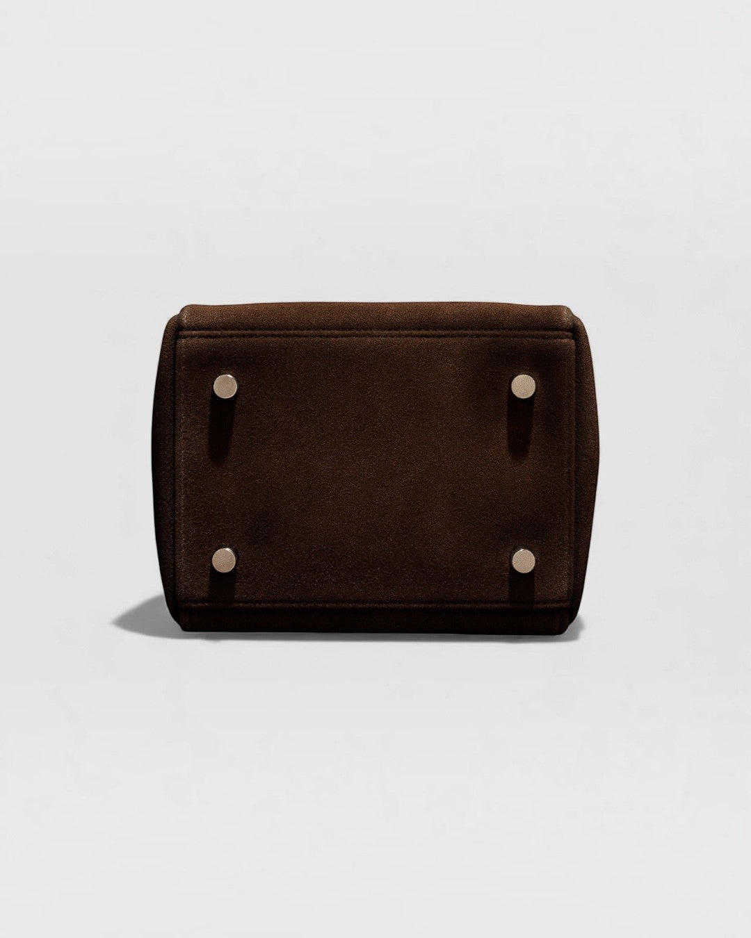 Pine Drew India Luna Umber handbag base showing four protective metal feet on rich brown suede-textured leather.